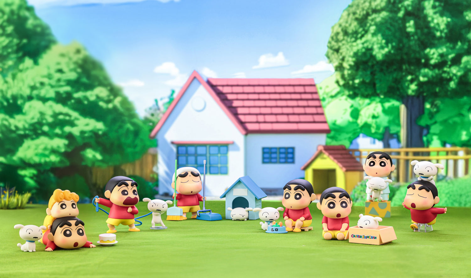 Toy figures of cartoon characters in front of a colorful house with greenery.