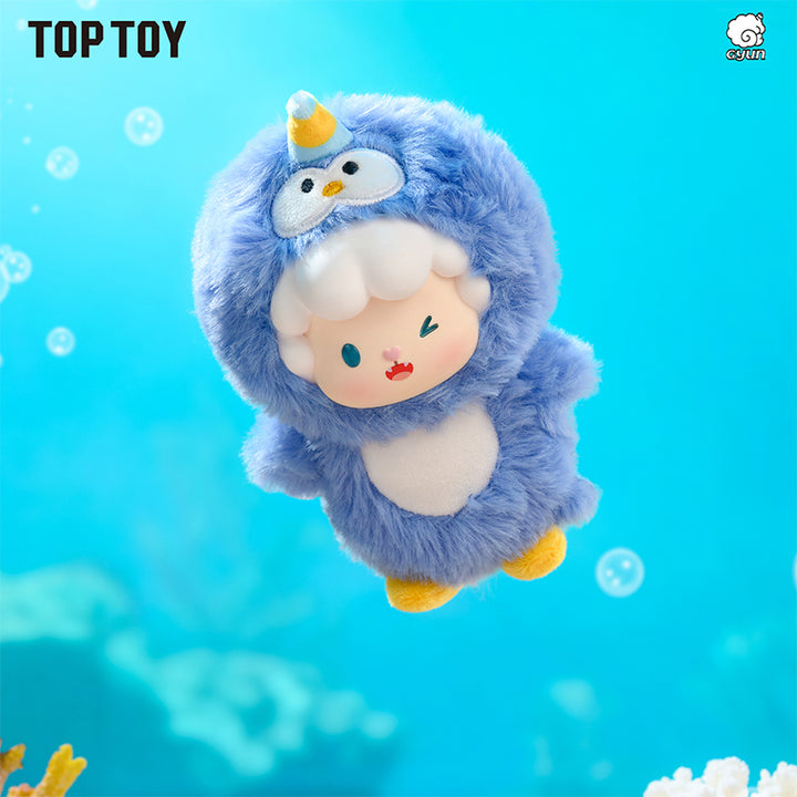 Plush toy with a blue creature and penguin design on a blue underwater background, featuring the brand 'Top Toy'.